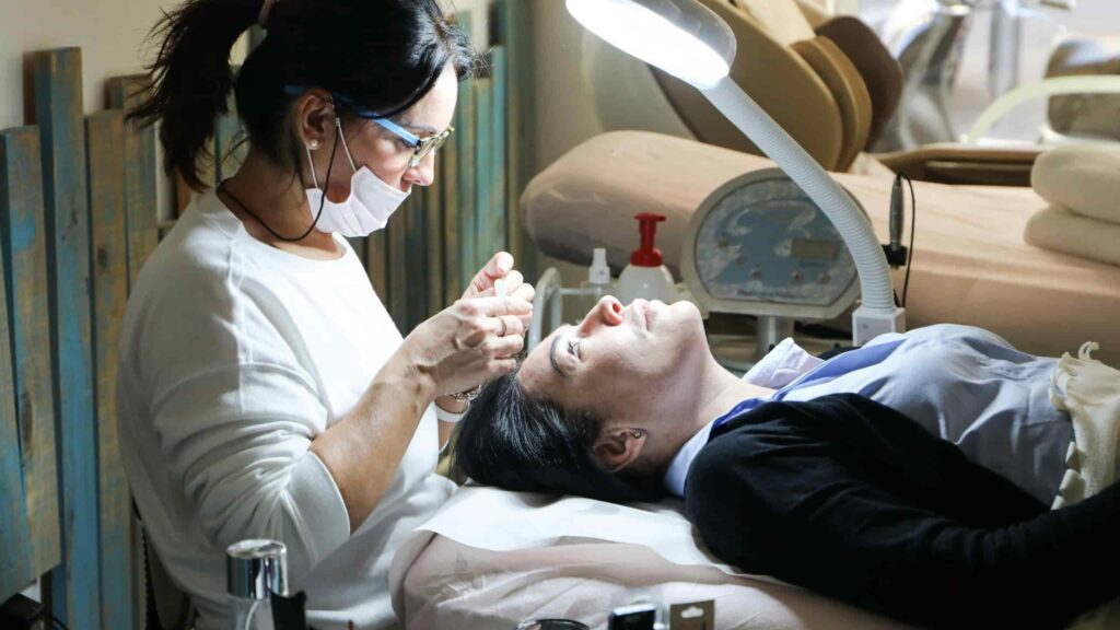 Tooth Extraction Treatment: When and Why It’s Needed Dentist performing tooth extraction treatment on patient